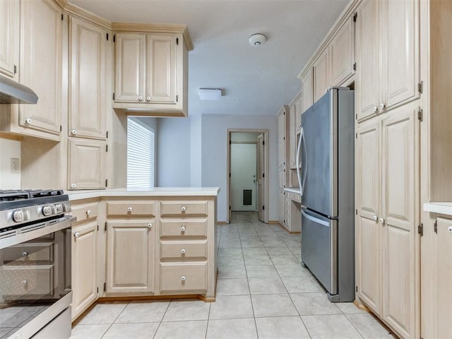 1312 Every Dr, Edmond, OK 73034 - kitchen featuring appliances with stainless steel finishes, a peninsula, light tile patterned flooring, under cabinet range hood, and light countertops
