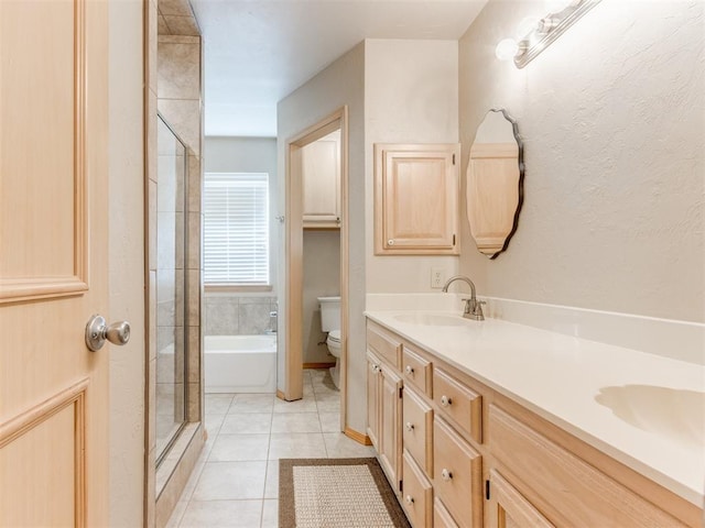 1312 Every Dr, Edmond, OK 73034 - full bathroom featuring toilet, a shower with door, double vanity, a tub to relax in, and tile patterned flooring