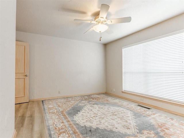 1312 Every Dr, Edmond, OK 73034 - spare room featuring ceiling fan, light wood-type flooring, and baseboards