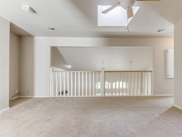 1312 Every Dr, Edmond, OK 73034 - empty room with ceiling fan, carpet, a skylight, and baseboards