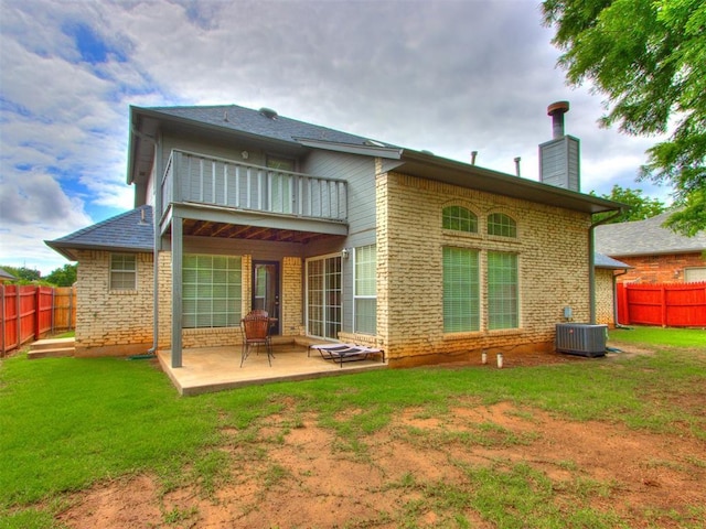 1312 Every Dr, Edmond, OK 73034 - back of property with a balcony, central air condition unit, a patio area, a chimney, and brick siding