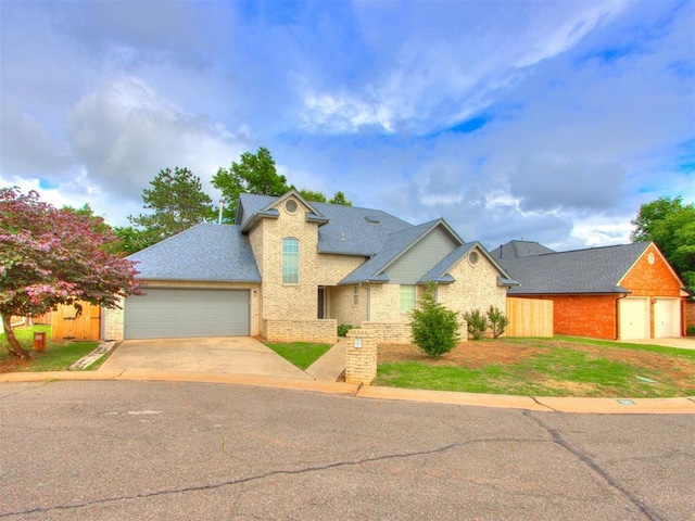 1312 Every Dr, Edmond, OK 73034 - traditional-style home with brick siding, concrete driveway, an attached garage, and roof with shingles