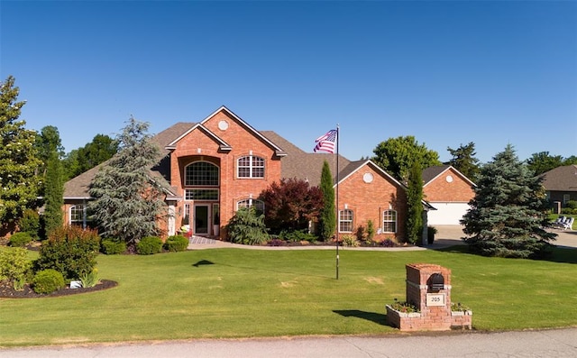 205 W Waterfront Dr, Tuttle, OK 73089 - traditional home with a front yard and brick siding