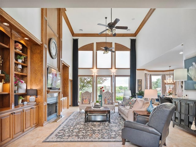 205 W Waterfront Dr, Tuttle, OK 73089 - living room with a towering ceiling, a ceiling fan, crown molding, and a fireplace
