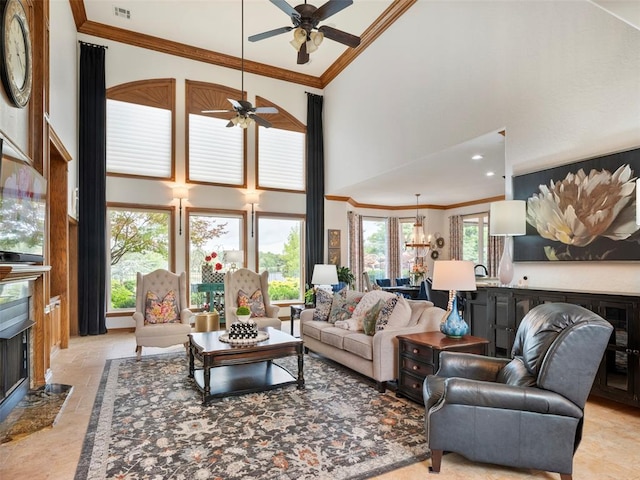 205 W Waterfront Dr, Tuttle, OK 73089 - living room with a fireplace, a high ceiling, ceiling fan, ornamental molding, and light stone finish floors