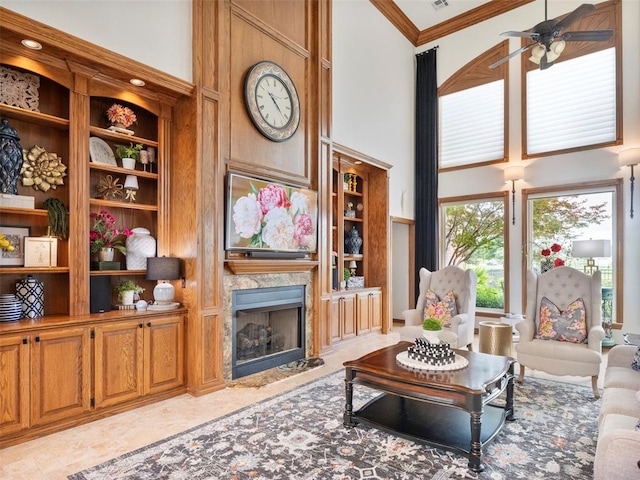 205 W Waterfront Dr, Tuttle, OK 73089 - living area featuring a high ceiling, ceiling fan, ornamental molding, built in shelves, and a premium fireplace
