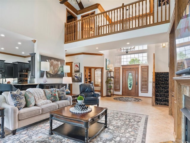 205 W Waterfront Dr, Tuttle, OK 73089 - living room featuring a towering ceiling, crown molding, and recessed lighting