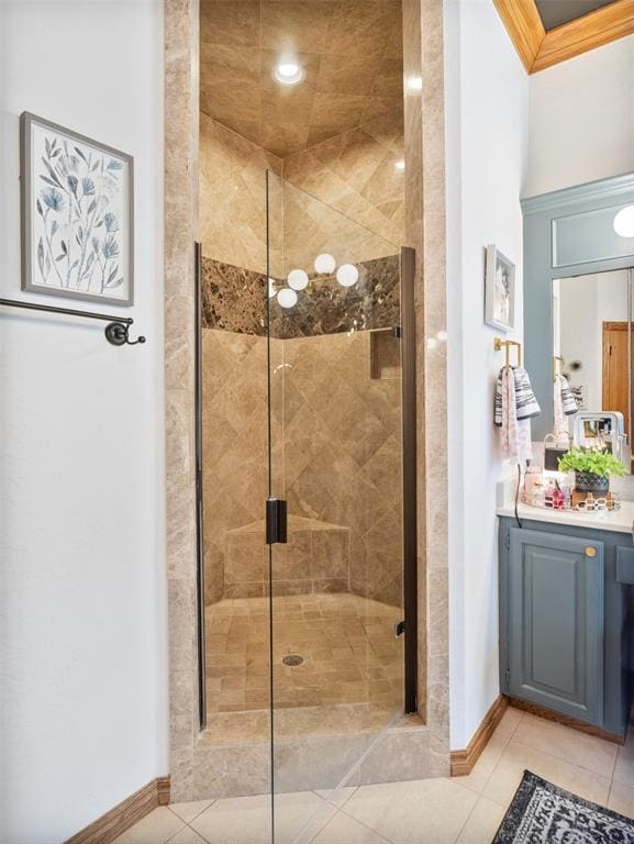 205 W Waterfront Dr, Tuttle, OK 73089 - bathroom featuring a stall shower, vanity, baseboards, tile patterned floors, and ornamental molding