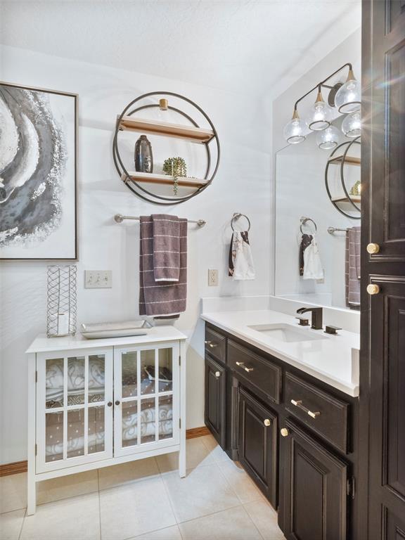 205 W Waterfront Dr, Tuttle, OK 73089 - bathroom featuring tile patterned flooring, vanity, and baseboards