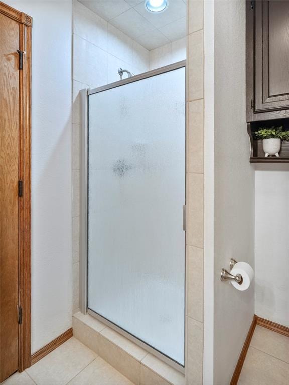 205 W Waterfront Dr, Tuttle, OK 73089 - full bath with a stall shower, tile patterned flooring, and baseboards