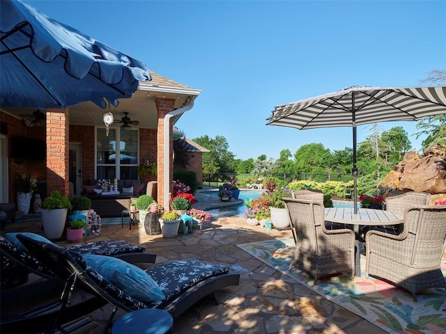 205 W Waterfront Dr, Tuttle, OK 73089 - view of patio / terrace with a ceiling fan, outdoor dining space, and an outdoor pool