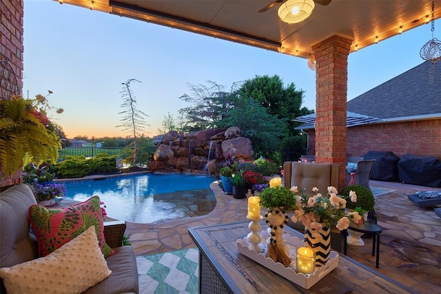 205 W Waterfront Dr, Tuttle, OK 73089 - pool at dusk featuring a fenced backyard, a patio area, ceiling fan, and area for grilling