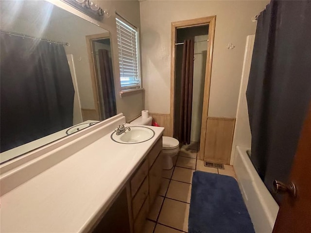 139 Sheridan Pl, Chickasha, OK 73018 - bathroom with toilet, vanity, wainscoting, tile patterned flooring, and shower / bath combination with curtain
