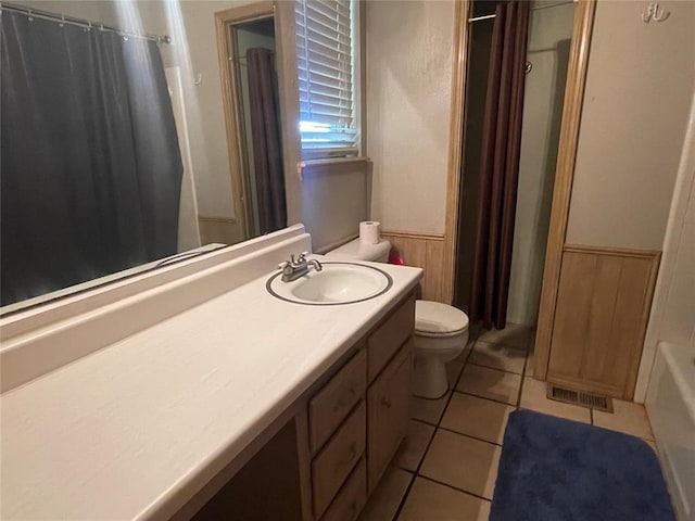 139 Sheridan Pl, Chickasha, OK 73018 - bathroom with toilet, a wainscoted wall, vanity, and tile patterned flooring