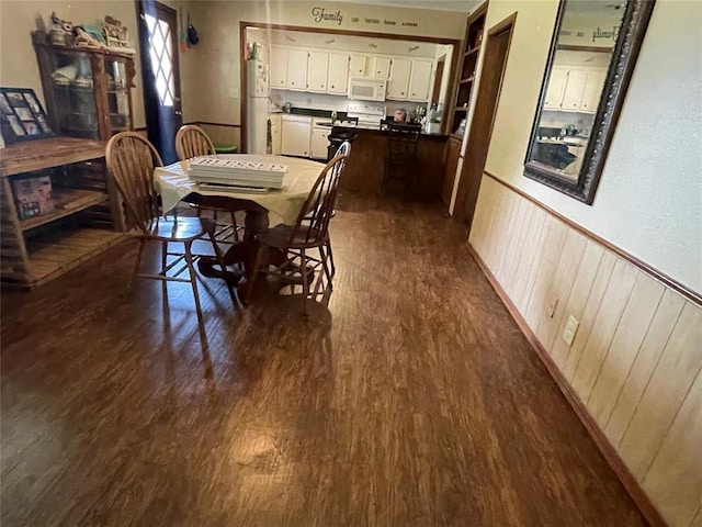 139 Sheridan Pl, Chickasha, OK 73018 - dining space with dark wood-style floors and wainscoting