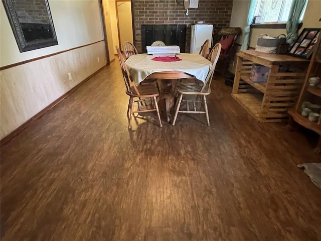 139 Sheridan Pl, Chickasha, OK 73018 - dining space featuring a brick fireplace and wood finished floors