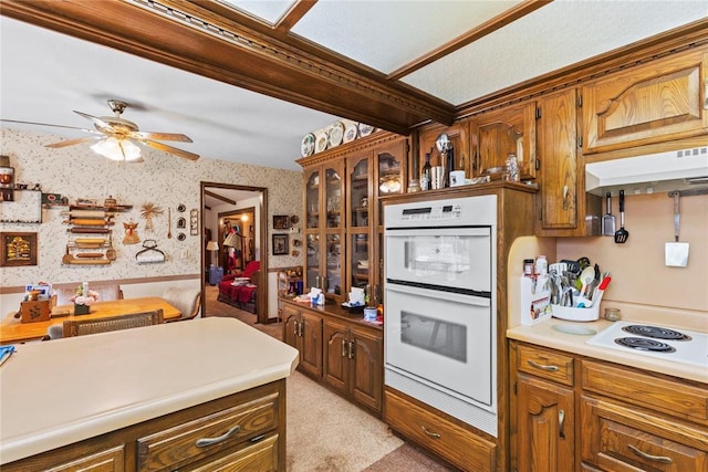 1205 Francis Ln, Kingfisher, OK 73750 - kitchen featuring white appliances, wallpapered walls, under cabinet range hood, a ceiling fan, and light carpet