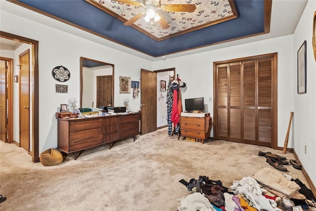 1205 Francis Ln, Kingfisher, OK 73750 - carpeted bedroom featuring a tray ceiling, a closet, ceiling fan, and baseboards