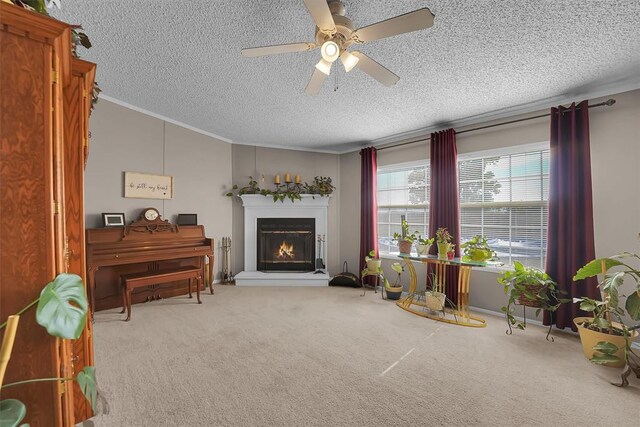 1318 N Cook St, Cordell, OK 73632 - living area with ceiling fan, carpet flooring, a warm lit fireplace, ornamental molding, and a textured ceiling