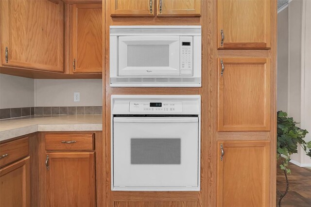 1318 N Cook St, Cordell, OK 73632 - kitchen featuring white appliances, light countertops, and brown cabinets