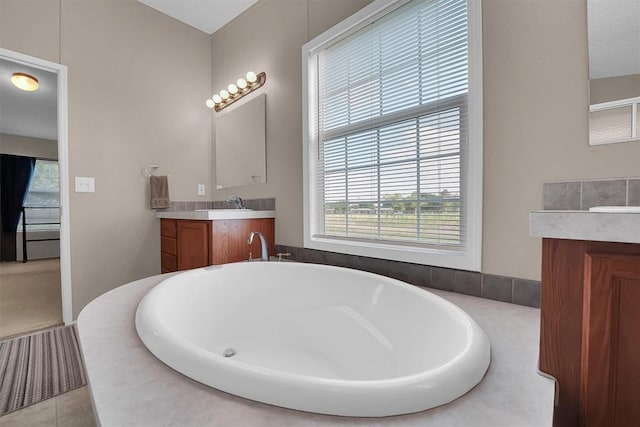 1318 N Cook St, Cordell, OK 73632 - bathroom with a tub, vanity, and healthy amount of natural light