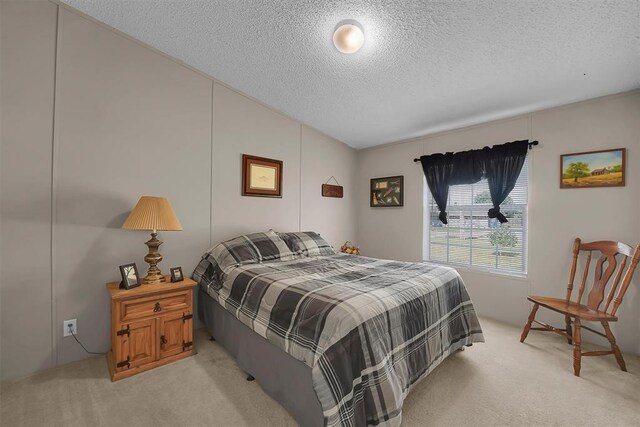 1318 N Cook St, Cordell, OK 73632 - bedroom with light colored carpet, a textured ceiling, and vaulted ceiling