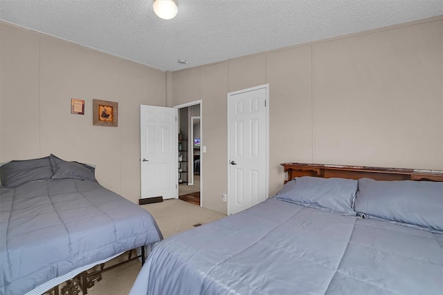 1318 N Cook St, Cordell, OK 73632 - bedroom with a textured ceiling, carpet, and a decorative wall
