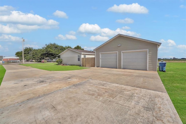 1318 N Cook St, Cordell, OK 73632 - view of side of property featuring a yard and a detached garage