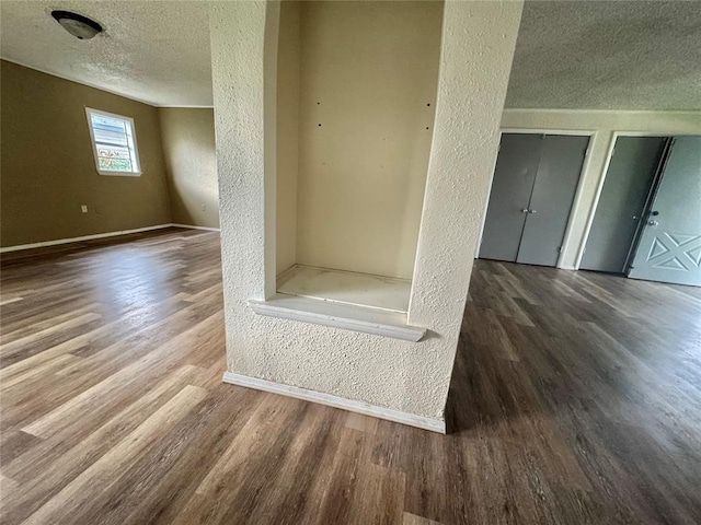 1502 S 12th St, Chickasha, OK 73018 - detailed view of a textured ceiling, a textured wall, wood finished floors, and baseboards