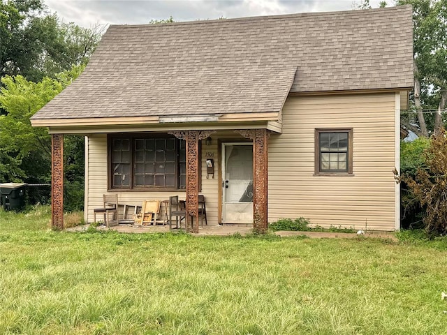 1502 S 12th St, Chickasha, OK 73018 - view of front of house featuring roof with shingles and a front lawn