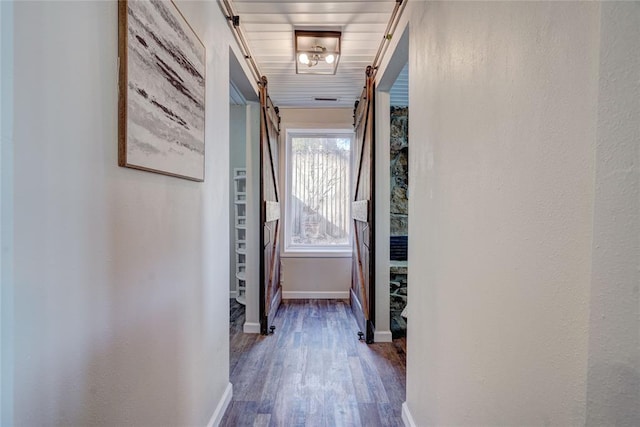 926 Park Cove Ln, Eucha, OK 74342 - corridor with wood finished floors, baseboards, and a barn door