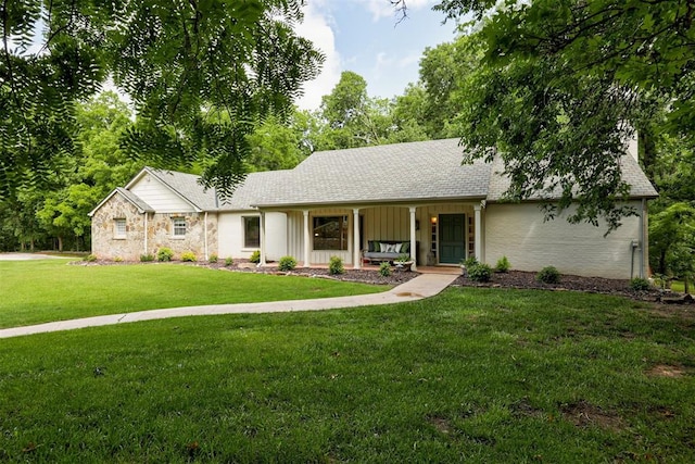 1736 Bryant Cir, Norman, OK 73026 - single story home featuring a porch, a front lawn, board and batten siding, and roof with shingles