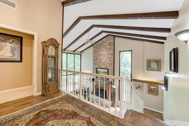 1736 Bryant Cir, Norman, OK 73026 - living area with wood finished floors, beam ceiling, ceiling fan, baseboards, and high vaulted ceiling