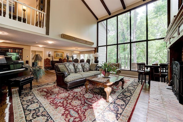 1736 Bryant Cir, Norman, OK 73026 - living room featuring high vaulted ceiling, wood finished floors, and beamed ceiling