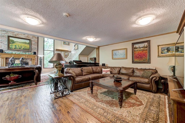 1736 Bryant Cir, Norman, OK 73026 - living area with stairway, a textured ceiling, ornamental molding, and wood finished floors