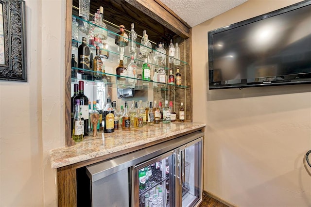 1736 Bryant Cir, Norman, OK 73026 - indoor dry bar featuring a textured ceiling and wine cooler
