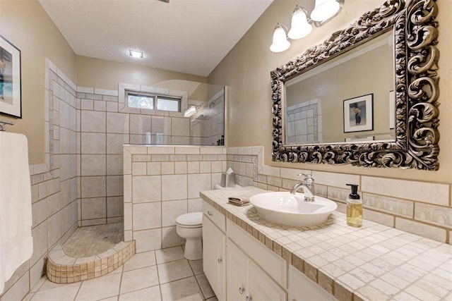 1736 Bryant Cir, Norman, OK 73026 - bathroom with toilet, a walk in shower, vanity, tile patterned floors, and tile walls