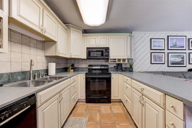 1736 Bryant Cir, Norman, OK 73026 - kitchen featuring black appliances, a sink, tasteful backsplash, and cream cabinetry