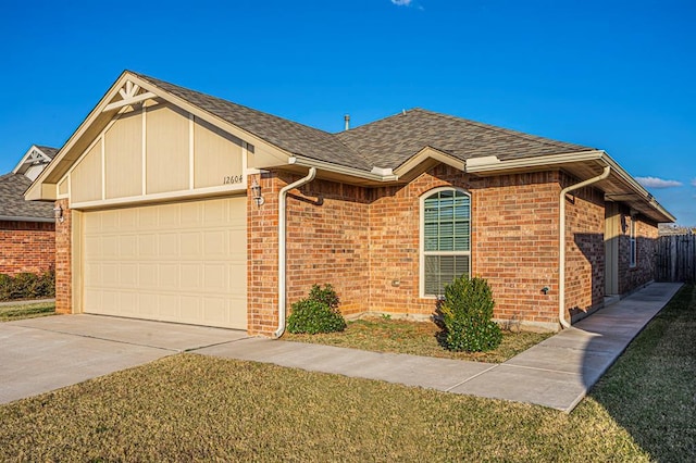 12604 William Penn Blvd, Oklahoma City, OK 73103 - view of front of home featuring an attached garage, driveway, a shingled roof, and brick siding