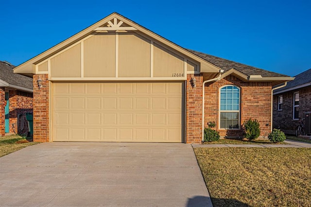 12604 William Penn Blvd, Oklahoma City, OK 73103 - ranch-style home featuring an attached garage, driveway, brick siding, and roof with shingles