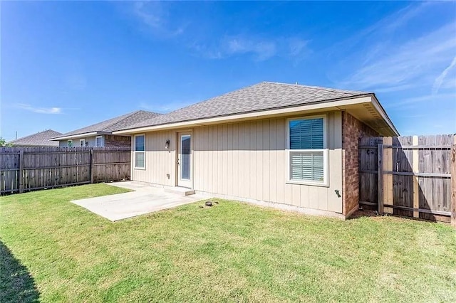 12604 William Penn Blvd, Oklahoma City, OK 73103 - rear view of house with a fenced backyard, a patio, and roof with shingles