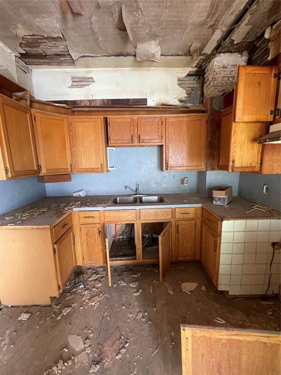 1624 W Idaho Ave, Chickasha, OK 73018 - kitchen with a sink, brown cabinetry, and extractor fan