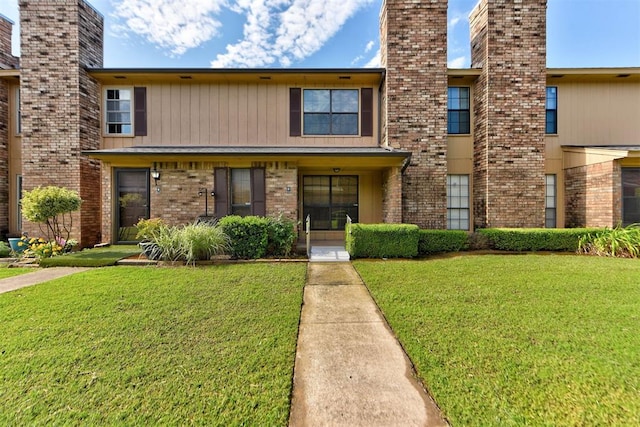 846 Two Forty Pl, Oklahoma City, OK 73139 - view of front of home with a front yard, brick siding, and a chimney