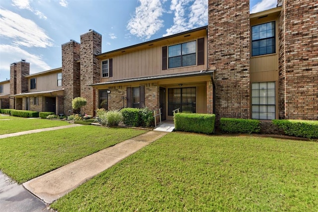 846 Two Forty Pl, Oklahoma City, OK 73139 - view of front of property with a front yard, a chimney, and brick siding