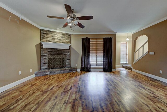 846 Two Forty Pl, Oklahoma City, OK 73139 - unfurnished living room with a ceiling fan, a brick fireplace, wood finished floors, and crown molding