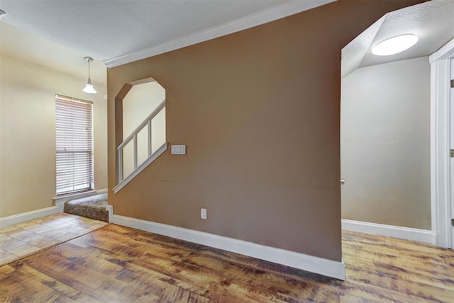 846 Two Forty Pl, Oklahoma City, OK 73139 - spare room featuring arched walkways, ornamental molding, and wood finished floors