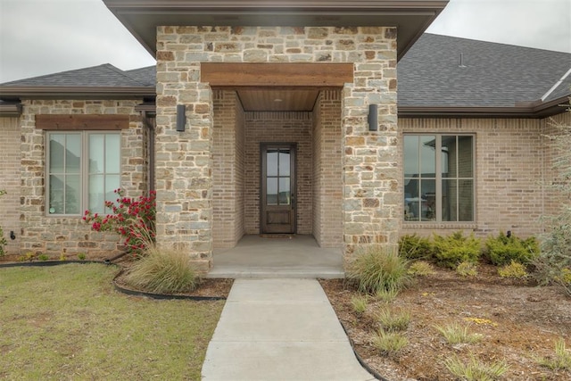 6524 NE 96th Cir, Oklahoma City, OK 73151 - property entrance with a shingled roof, brick siding, and stone siding