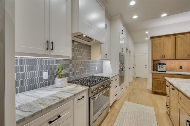 6524 NE 96th Cir, Oklahoma City, OK 73151 - kitchen featuring appliances with stainless steel finishes, custom exhaust hood, light wood-type flooring, decorative backsplash, and light stone counters