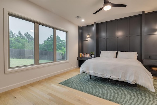 6524 NE 96th Cir, Oklahoma City, OK 73151 - bedroom with light wood-style flooring, a decorative wall, recessed lighting, and ceiling fan