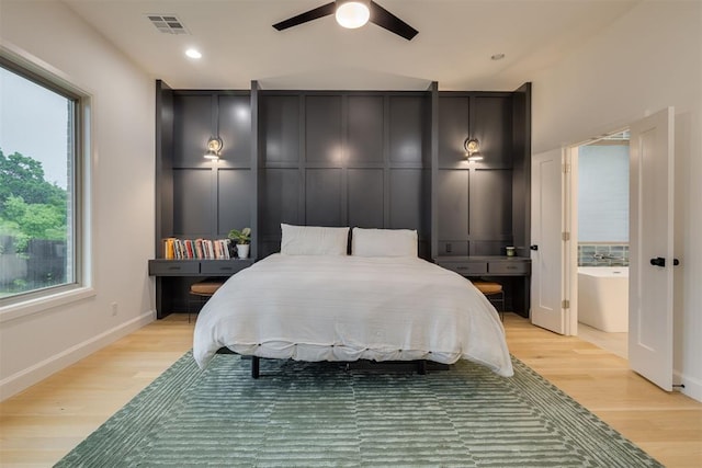 6524 NE 96th Cir, Oklahoma City, OK 73151 - bedroom with light wood finished floors and a ceiling fan